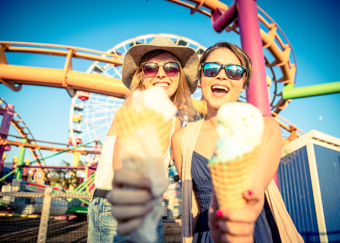 women holding ice cream cones ice cream at a theme park